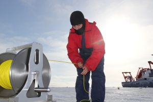Researcher collects data below the ice.